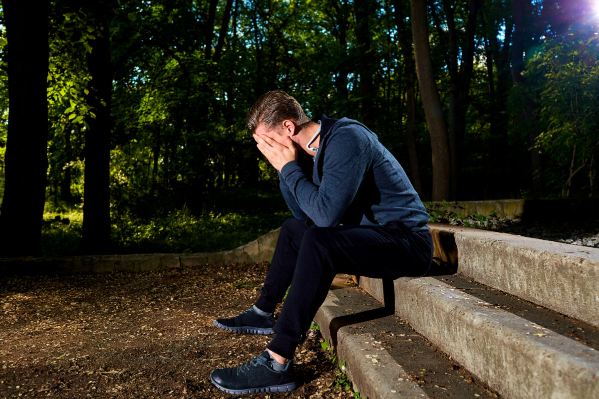 Defeat concept. The defeated sportsman covered his face with his hands